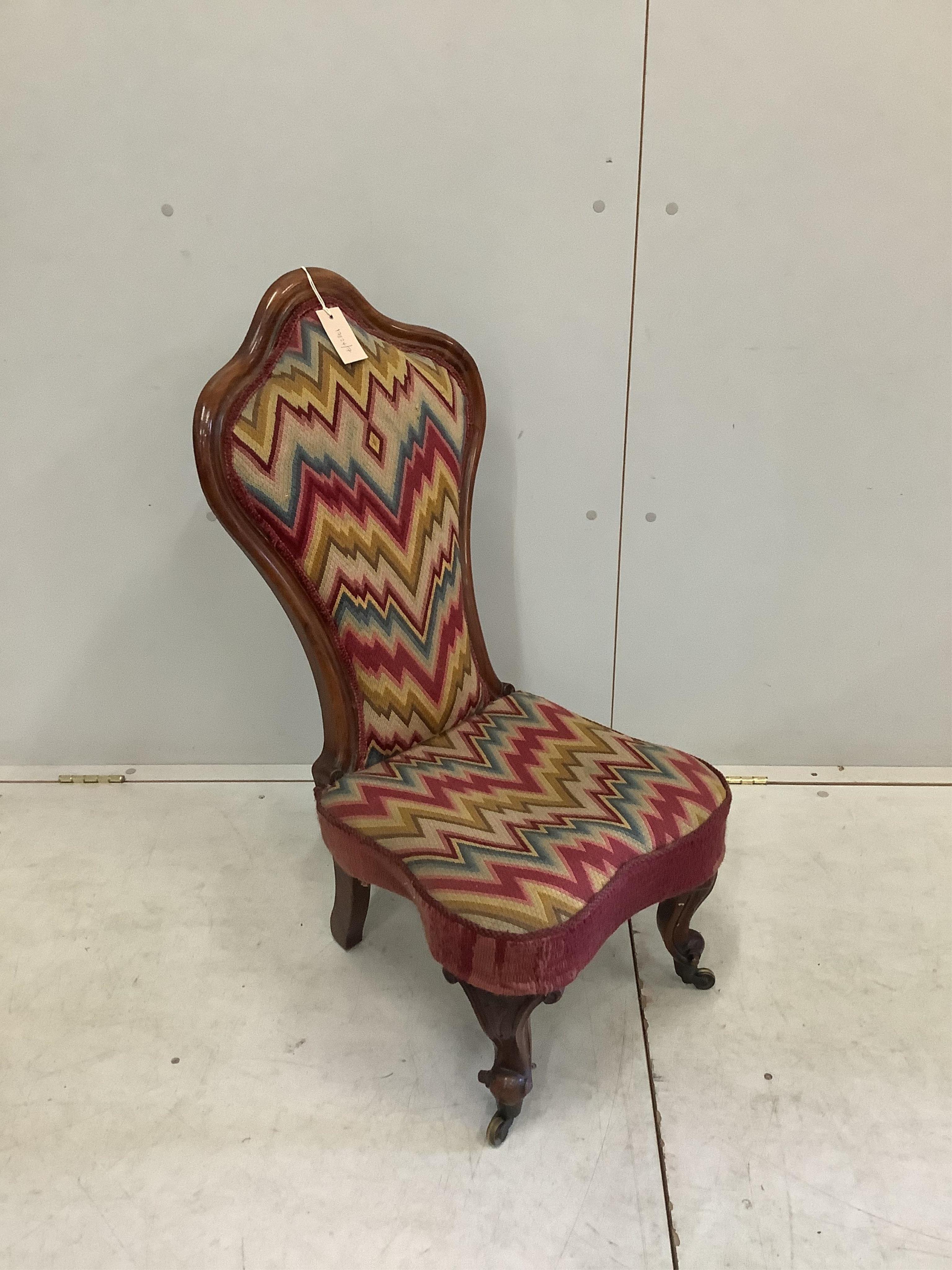 A Victorian rosewood nursing chair, width 40cm, height 87cm